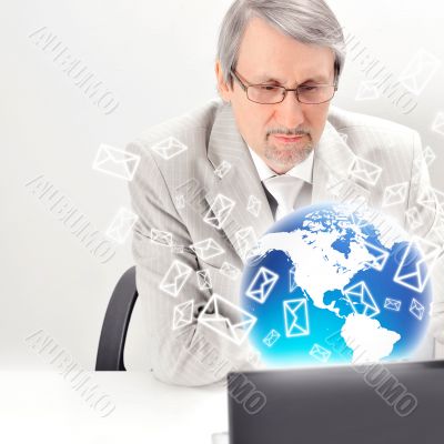 Portrait of an older businessman with a computer and a cup.