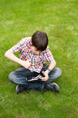 Young boy outdoors on the grass at backyard