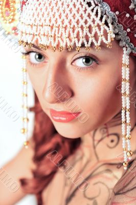 Closeup portrait of pretty young woman with red hairs posing nea