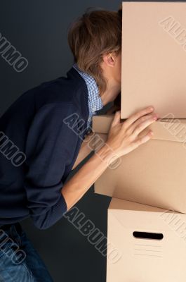 Portrait of anonymous young man with his head inside box