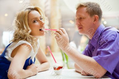 Closeup portrait of young cute couple at mall cafe. Man proposin