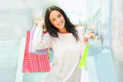 Photo of young joyful woman with shopping bags on th