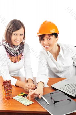 Portrait of two young women discussing construction project.