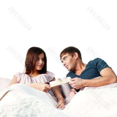 Closeup portrait of a happy young couple relaxing on the bed. Ma