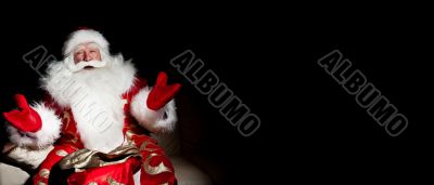 Santa sitting with a sack indoor at dark night room