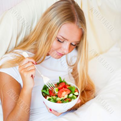 Closeup portrait of a beautiful slender girl eating healthy food