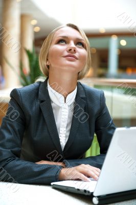 Portrait of a pretty businesswoman sitting at cafe with a laptop