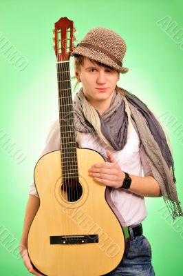 Closeup portrait of cute caucasian man playing the guitar over g