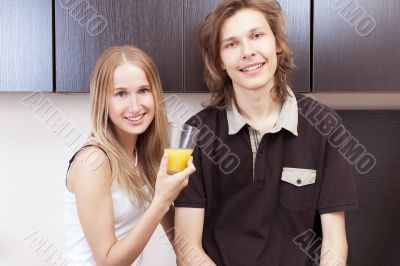 Playful young couple in their kitchen.
