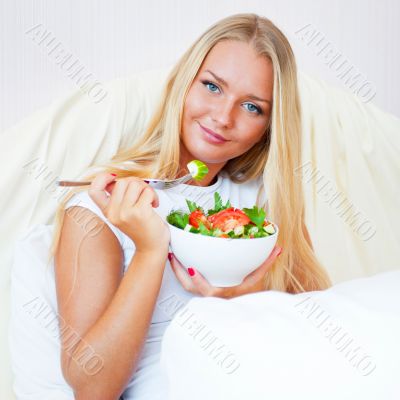 Closeup portrait of a beautiful slender girl eating healthy food Closeup portrait of a beautiful slender girl eating healthy food