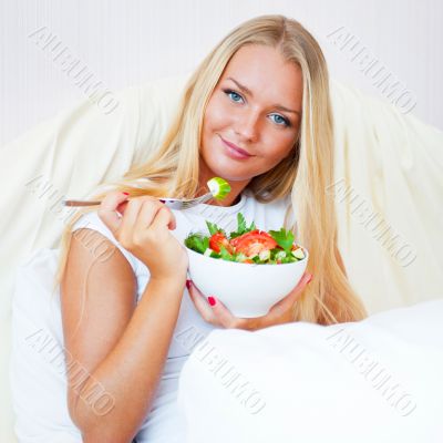 Closeup portrait of a beautiful slender girl eating healthy food