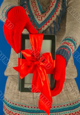 Girl holds electronic book reader with red gloves