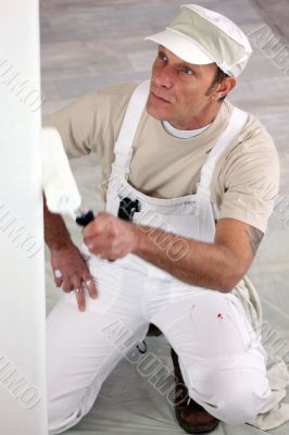 Tradesman painting a wall Tradesman painting a wall
