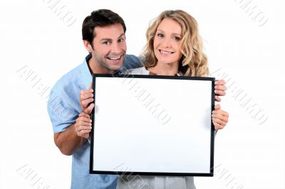 Couple holding white board Couple holding white board