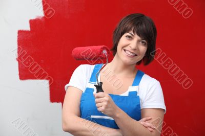 Woman painting wall in red