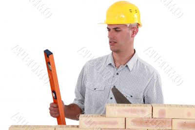 mason holding a level and a trowel mason holding a level and a trowel