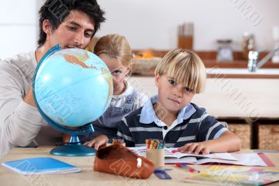 Brother and sister doing geography homework