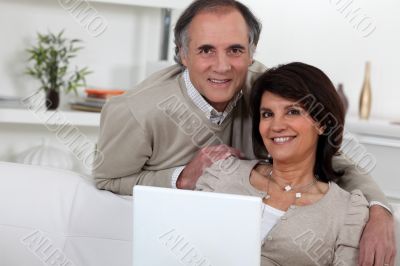 Middle-aged couple with laptop