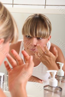 portrait of a woman applying make-up portrait of a woman applying make-up