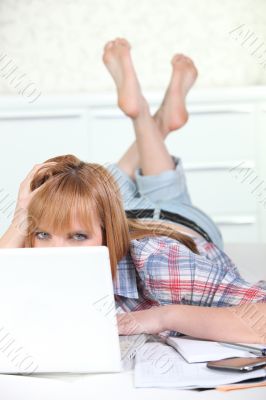 Young woman laid in front of computer Young woman laid in front of computer