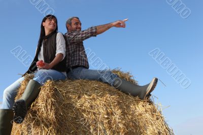 portrait of a couple on a hay bale