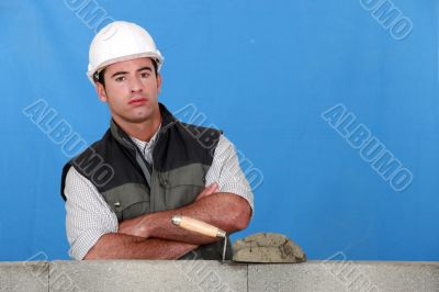 Bricklayer with a block wall