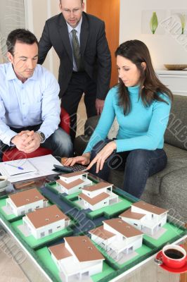 Couple calculating the cost of their new home