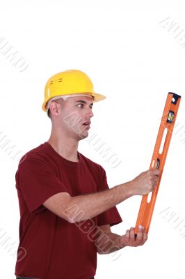 A manual worker with a level. A manual worker with a level.