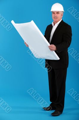 Architect standing on blue background