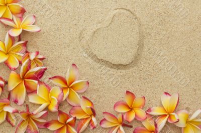 Frangipani/plumeria flower frame, with print of heart, on sand