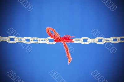 Broken chain connected with red threads 