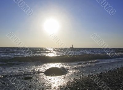 Lonely sail drifting under the big sun