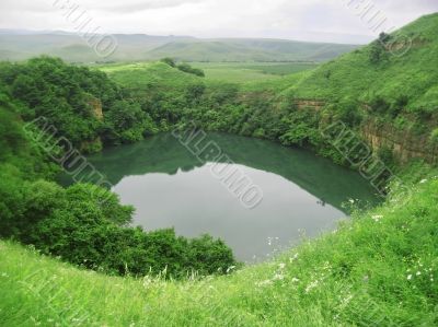 Small lake between the caucasus mountains summertime