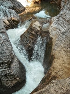 Waterfall between the rocks. North Caucas nature