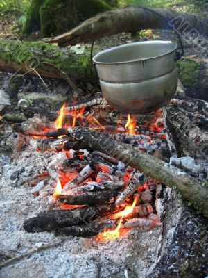 Water for tea boiling on the bonfire