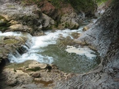 Waterfall between the rocks. North Caucas nature