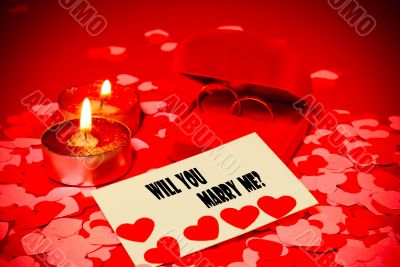 Card with marriage proposal and two rings and two candles