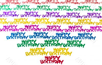 Colourful background of multicolored happy birthday confetti pieces
