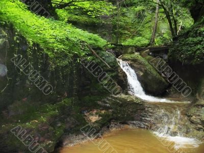 Waterfall between the rocks. The Caucasus nature