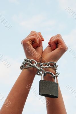 Hands tied up with chains