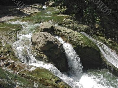 Waterfall between the rocks. The Caucasus nature