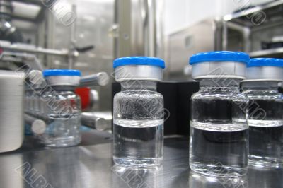 Bottles in the processing machine in a pharmaceutical plant