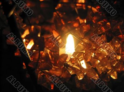 Flaming candle in basket and dark background Flaming candle in basket and dark background