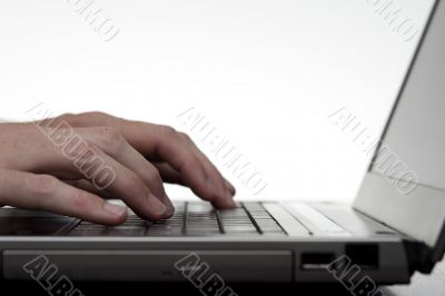 Hands Typing On Laptop Keyboard