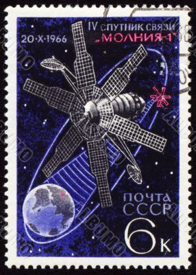 Postage stamp with communication satellite in space