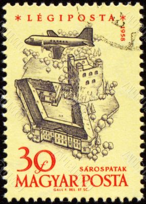 Flying plane over the medieval castle on post stamp
