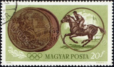 Sportsman riding horse and Olympic medal on post stamp