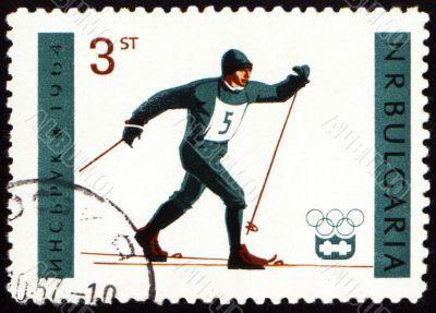 Running skier on post stamp