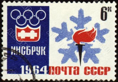 Olympic torch and emblem on post stamp