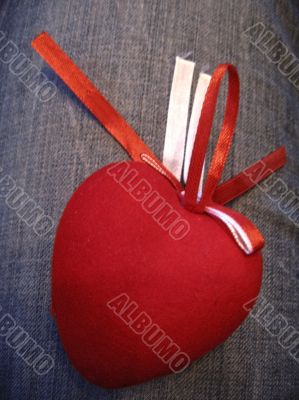 Red heart with red and white stripes on the jeans background Red heart with red and white stripes on the jeans background